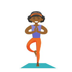 Image showing African-american woman practicing yoga tree pose.