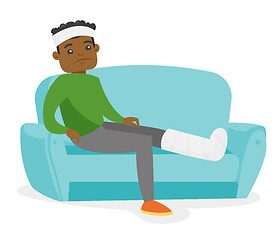 Image showing African man with broken leg sitting on the couch.