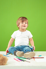 Image showing Portrait of happy little boy over green background