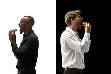 Image showing Men eating a hamburger and donut on a black and white background