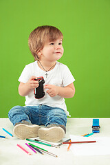 Image showing Portrait of happy little boy over green background