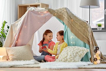 Image showing little girl playing tea party in kids tent at home