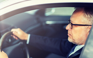 Image showing happy senior businessman driving car