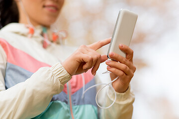 Image showing woman listening to music on smartphone outdoors