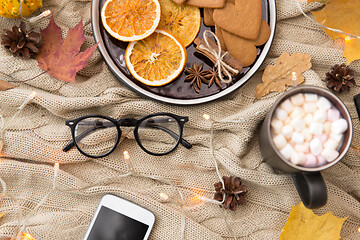 Image showing smartphone, hot chocolate and autumn leaves