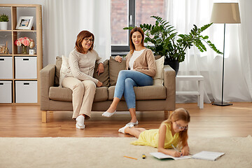 Image showing mother and grandmother looking at daughter at home