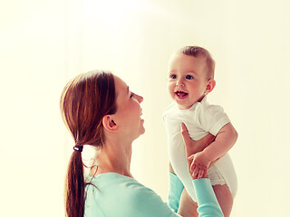 Image showing happy young mother with little baby at home