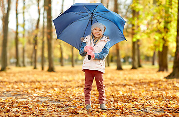 Image showing happy little girl with umbrella at autumn park