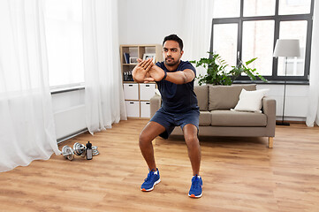 Image showing indian man exercising and doing squats at home