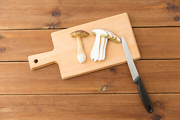 Image showing edible mushrooms, kitchen knife and cutting board