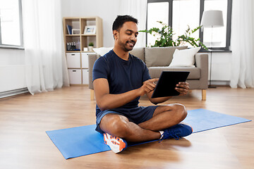 Image showing indian man with tablet pc and exercise mat at home