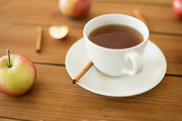 Image showing cup of tea with apples and cinnamon on table