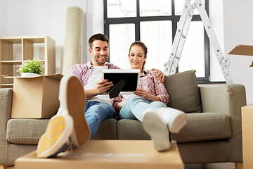 Image showing happy couple with boxes moving to new home