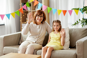 Image showing grandmother and granddaughter on birthday at home