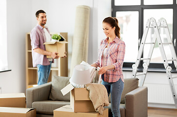 Image showing happy couple with stuff moving to new home