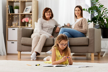 Image showing student girl with notebook lying on floor at home