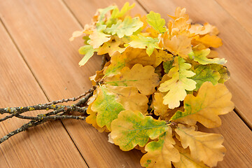 Image showing oak leaves in autumn colors on wooden table