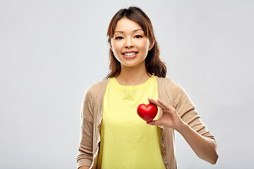 Image showing happy asian woman holding red heart