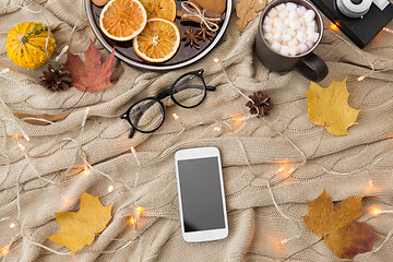 Image showing smartphone, hot chocolate and autumn leaves