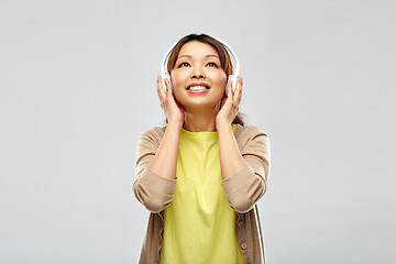 Image showing asian woman in headphones listening to music