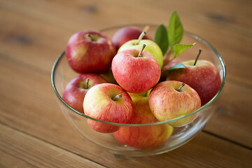 Image showing ripe apples in glass bowl on wooden table