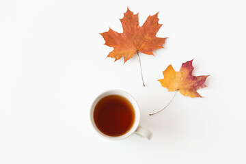 Image showing cup of black tea and autumn maple leaves