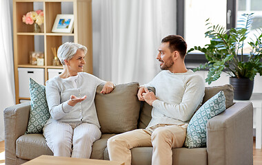 Image showing senior mother talking to adult son at home