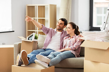 Image showing happy couple with boxes moving to new home