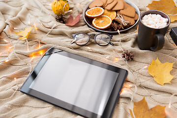 Image showing tablet computer, hot chocolate and autumn leaves