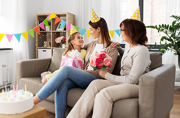 Image showing daughter with gift box greeting mother on birthday