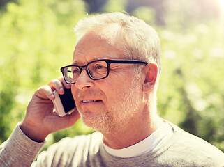 Image showing happy senior man calling on smartphone in city