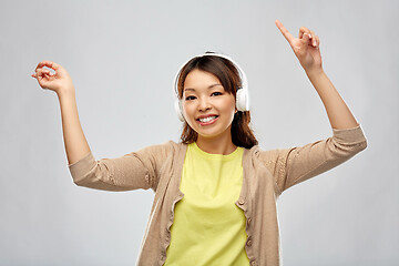 Image showing asian woman in headphones listening to music