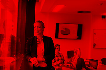 Image showing portrait of young business woman at office with team on meeting 