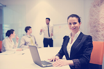 Image showing young business woman on meeting  using laptop computer