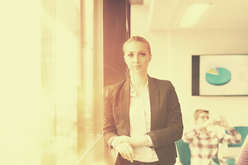 Image showing portrait of young business woman at office with team on meeting 