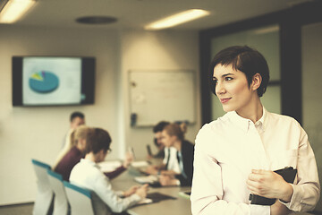 Image showing hispanic businesswoman with tablet at meeting room