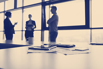 Image showing close up of tablet, business people on meeting in background