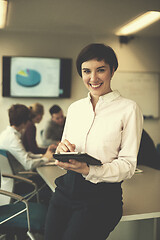 Image showing hispanic businesswoman with tablet at meeting room