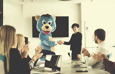 Image showing boss dresed as bear having fun with business people in trendy of