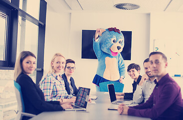 Image showing boss dresed as bear having fun with business people in trendy of