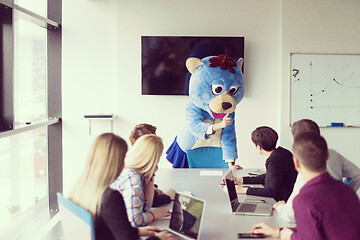 Image showing boss dresed as bear having fun with business people in trendy of