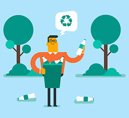 Image showing Man picking up plastic bottle in a recycling bin.