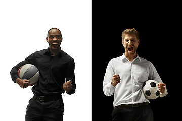Image showing Portrait of a smiling men holding soccer and basketball ball isolated on a white and black background