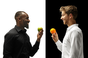 Image showing Men eating a fruits on a black and white background
