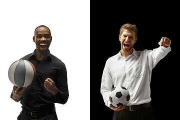 Image showing Portrait of a smiling men holding soccer and basketball ball isolated on a white and black background