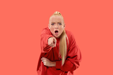 Image showing The overbearing business woman point you and want you, half length closeup portrait on coral background.