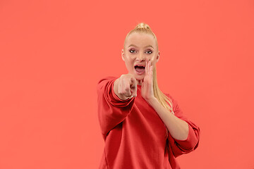 Image showing The overbearing business woman point you and want you, half length closeup portrait on coral background.