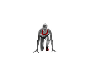 Image showing Portrait of young sporty woman at starting block of race isolated over white background