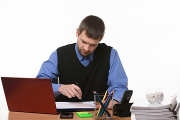 Image showing disgruntled manager checks graphs in documents on a white background