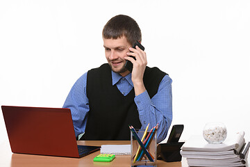 Image showing Office worker talks on the phone with customers